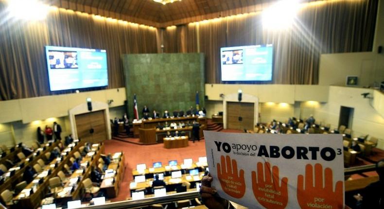 Activists holding placards supporting abortion take part in a demonstration inside the National Congress in Valparaiso, Chile, on July 20, 2017