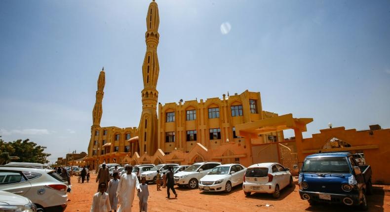 Sudanese worshippers arrive outside a mosque to attend the weekly Friday sermon and prayers during the holy month of Ramadan in the capital Khartoum