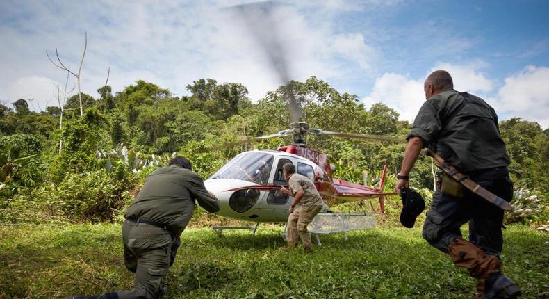 Former British Special Air Service soldiers prepare a helicopter carrying a team of scientists for liftoff from a secret location in the Mosquitia jungle.
