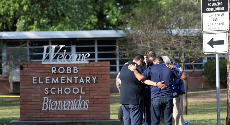 People gather at Robb Elementary School, the scene of a mass shooting in Uvalde, Texas.