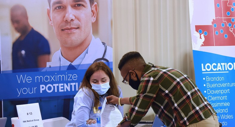 A man handing his rsum to an employer at the 25th annual Central Florida Employment Council Job Fair at the Central Florida Fairgrounds.
