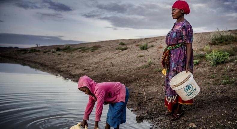 Martha Kasafi and her daughter, refugees from Democratic Republic of Congo, collect water for their crops in Kalobeyei settlement for refugees in  Kenya on October 2, 2019; Independent experts on the Human Rights Committee issued a non-binding ruling in a case brought by Ioane Teitiota from the Pacific island nation of Kiribati