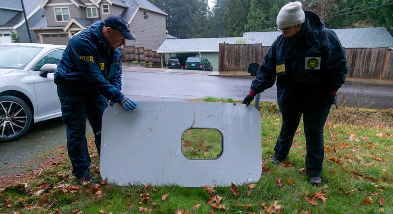 National Transportation Safety Board investigators examine the door plug found in a backyard in Portland, Oregon.NTSB via Reuters