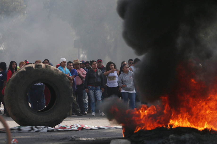 Protesters block the entrance to a Pemex gas station as they burn tires during a protest against the rising prices of gasoline enforced by the Mexican government, in San Miguel Totolcingo, Mexico, January 3, 2017.