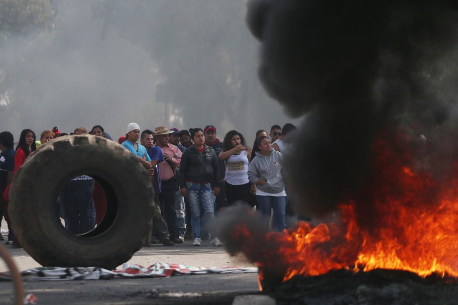 Protesters block the entrance to a Pemex gas station as they burn tires during a protest against the rising prices of gasoline enforced by the Mexican government, in San Miguel Totolcingo, Mexico, January 3, 2017.