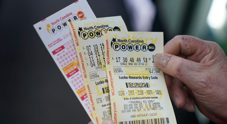 A customer holds Powerball tickets.Erik Verduzco/AP