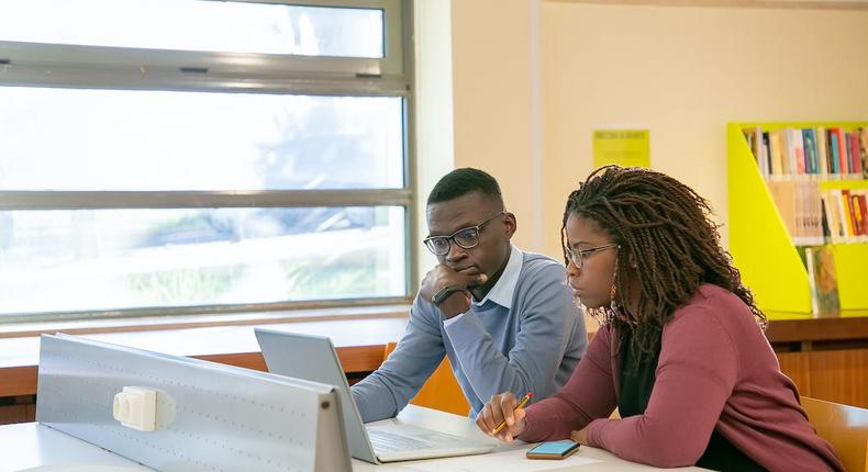 Students preparing a presentation for studies in a classroom [Image: Kampus Production]