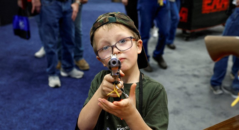 Hudson Eckart, 6, from Indiana, tries out a gun during the National Rifle Association (NRA) annual convention.Evelyn Hockstein/Reuters