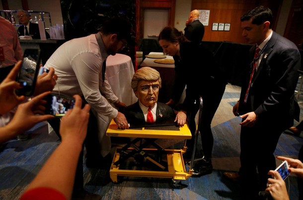 A cake in the form of Republican U.S. presidential nominee Donald Trump is brought into the hotel wh