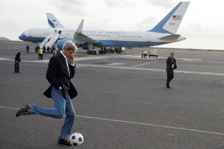 Kerry kicks a soccer ball around during an airplane refueling stop at Sal Island, Cape Verde, enroute to Washington, DC, May 5, 2014.
