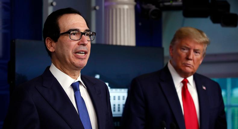 FILE - In this April 13, 2020, file photo President Donald Trump listens as Treasury Secretary Steven Mnuchin speaks about the coronavirus in the James Brady Press Briefing Room at the White House in Washington. The Trump administration and Congress are nearing an agreement as early as Sunday, April 19, on a $400-plus billion aid package to boost a small-business loan program that has run out of money and add funds for hospitals and COVID-19 testing.  (AP Photo/Alex Brandon, File)