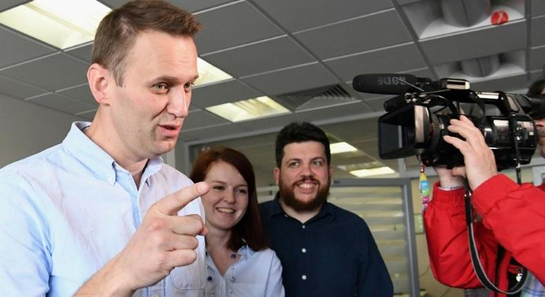 Russian opposition leader Alexei Navalny makes a statement for media at his office in Moscow shortly after being released from jail