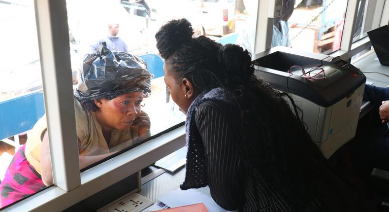 URA staff talking to a business woman