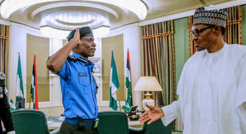 The Inspector-General of Police (IGP), Mohammad Adamu salutes President Muhammadu Buhari during his appointment as acting IGP (Channels TV)