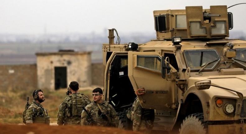 Members of the Syrian Democratic Forces (SDF) and US soldiers patrol the Kurdish-held town of Al-Darbasiyah in northeastern Syria bordering Turkey on November 4, 2018