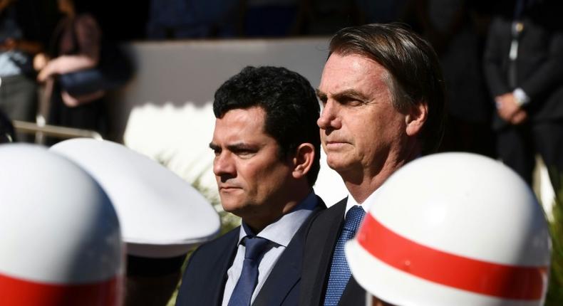 Brazilian President Jair Bolsonaro (R) and his Justice Minister Sergio Moro, who is under fire over accusations he acted improperly as a judge in a sprawling corruption case