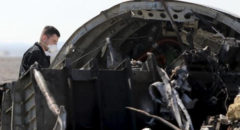 A military investigator from Russia stands near the debris of a Russian airliner at its crash site at the Hassana area in Arish city, north Egypt, November 1, 2015. REUTERS/Mohamed Abd El Ghany