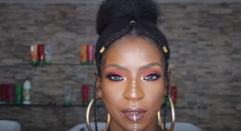 Fulani Inspired braids with vibrant glowing makeup look