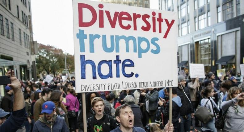 A man shouts slogans during a protest against US President-elect Donald in front of Trump Tower in New York on November 19, 2016