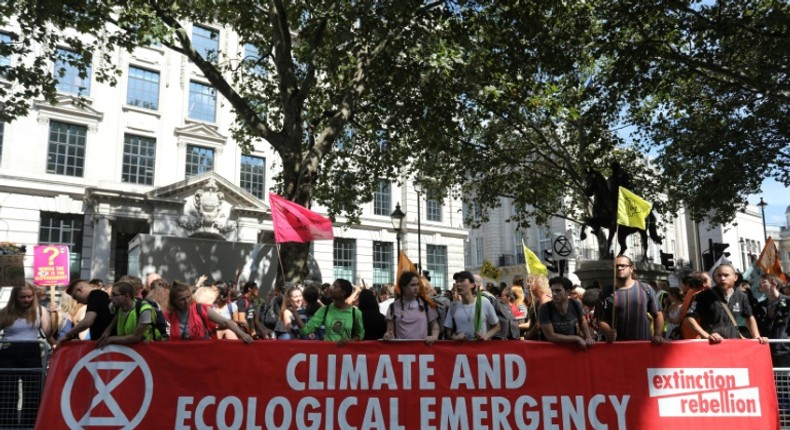 Protesters with placards gather for a demonstration organised by climate change activists from Extinction Rebellion outside the Brazilian embassy in central London on August 23, 2019 calling on Brazil to act to protect the Amazon rainforest from deforestation and fire. Climate change activists demonstrated outside the Brazilian embassy in London on August 23, urging President Jair Bolsonaro to halt the fires in the Amazon rainforest. Protests were also planned for other European cities. Official figures show nearly 73,000 forest fires were recorded in Brazil in the first eight months of the year -- the highest number for any year since 2013. Most were in the Amazon.