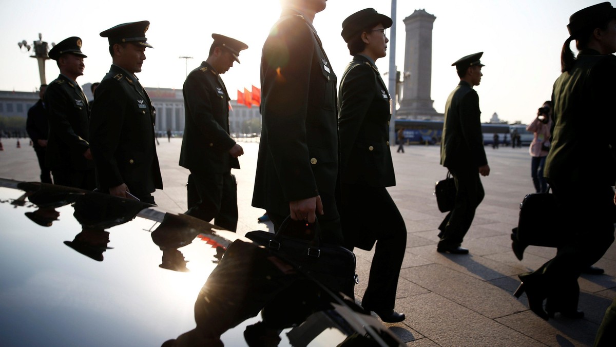 Military delegates arrive for the closing ceremony of NPC at the Great Hall of the People in Beijing