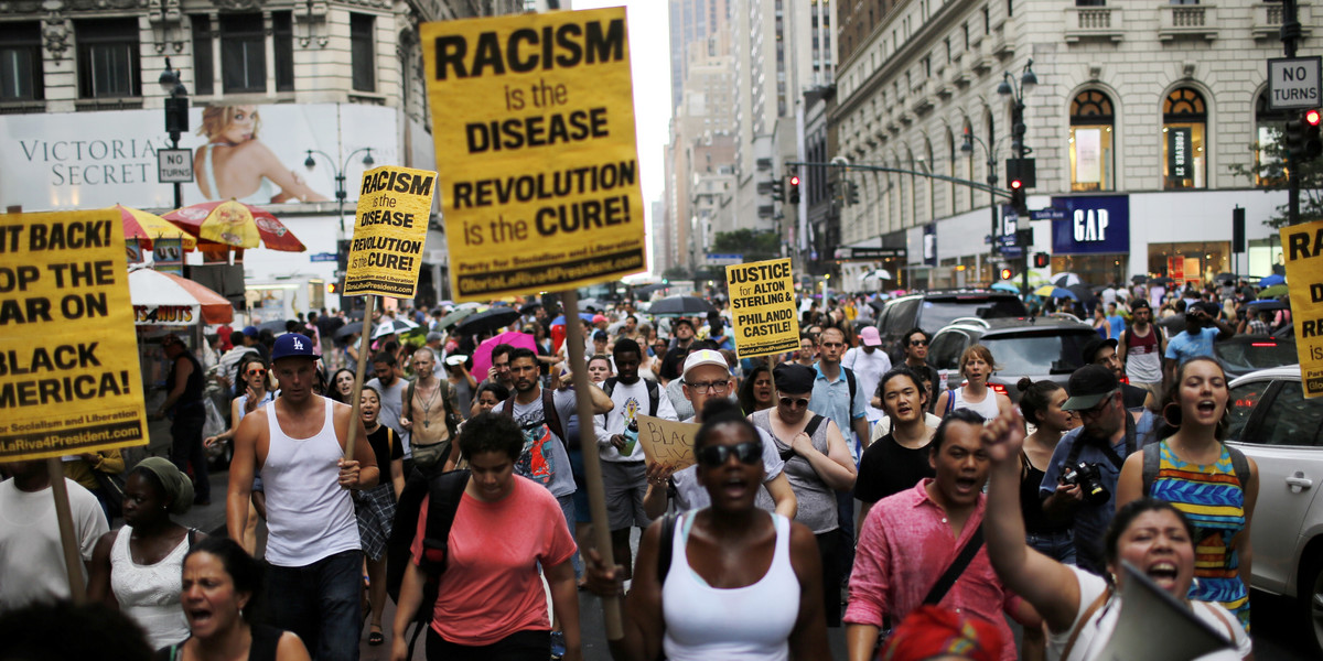 People take part in a protest for the killing of Alton Sterling and Philando Castile during a march along Manhattan's streets in New York July 7, 2016.