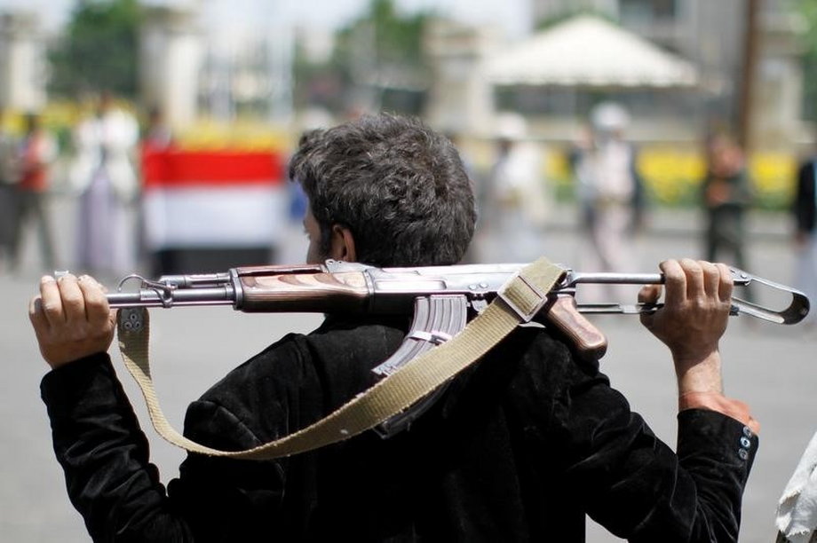 An armed man loyal to the Houthi movement holds his weapon as he gathers to protest against the Saudi-backed exiled government deciding to cut off the Yemeni central bank from the outside world, in the capital Sanaa.