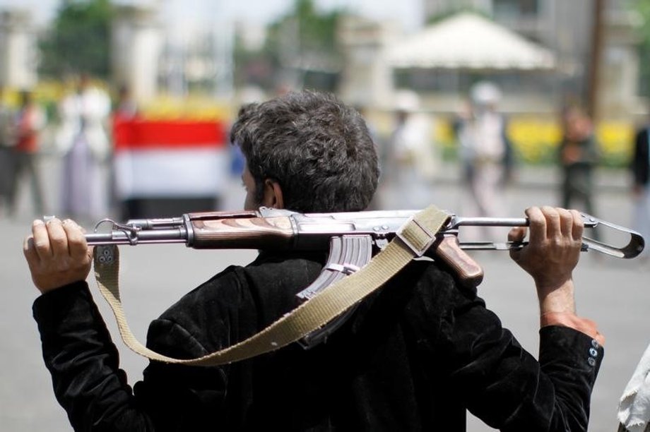 An armed man loyal to the Houthi movement holds his weapon as he gathers to protest against the Saudi-backed exiled government deciding to cut off the Yemeni central bank from the outside world, in the capital Sanaa.