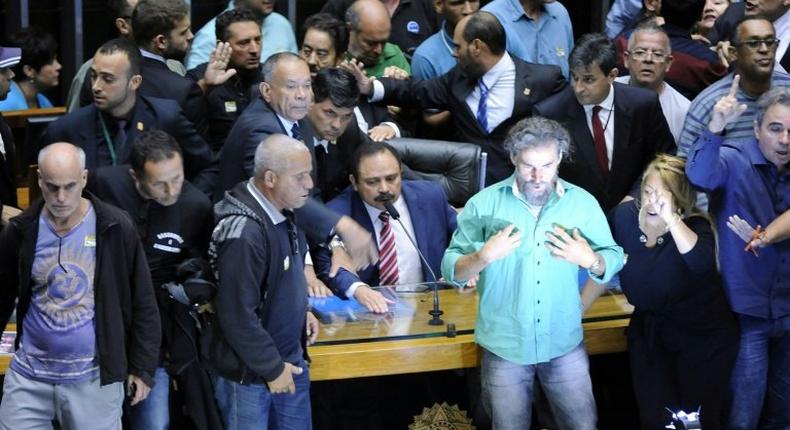 Some 40 people swept past security guards and broke a glass door to invade Brazil's legislative chamber to demand a military coup