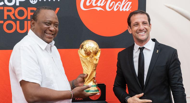 President Uhuru Kenyatta receives FIFA World Cup Trophy at State House, Nairobi on May 26. On the left is 2002 World Cup winner, Brazilian Juliano Belleti, a FIFA World Cup Tour ambassador