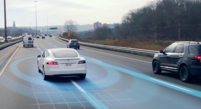 A visual rendering of a Tesla driving with Autopilot activated.