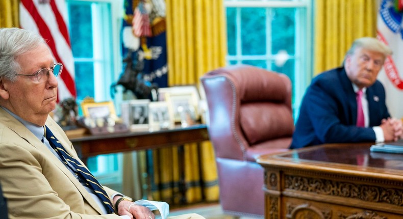 Senate Majority Leader Mitch McConnell listens to President Donald Trump talks to reporters while hosting Republican congressional leaders and members of Trump's cabinet in the Oval Office at the White House July 20, 2020, in Washington, DC.
