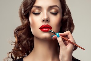 Make up artist is working with face of gorgeous model. Cosmetic, manicure and make up.