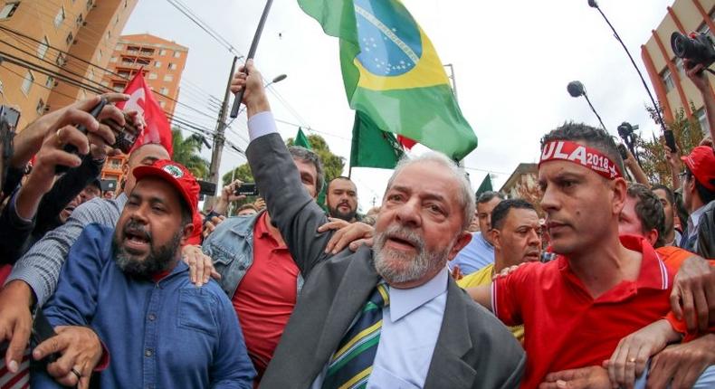 Brazil's former president Luiz Inacio Lula da Silva walks amid supporters as he arrives at a Federal Justice Court in Curitiba on May 10, 2017