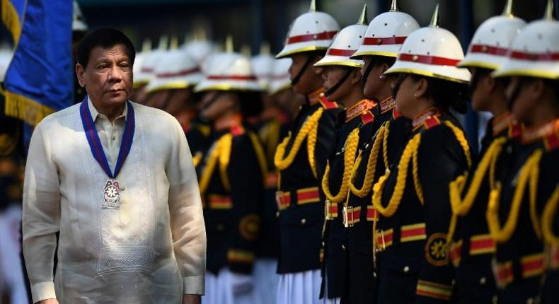 Philippine President Rodrigo Duterte inspects a police honour guard