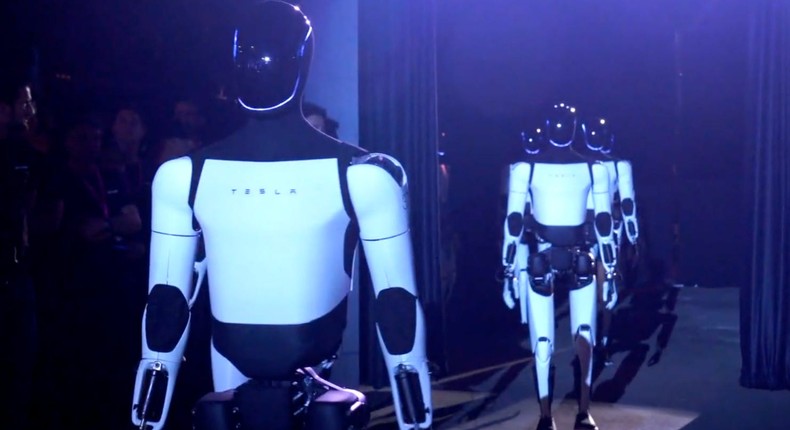 Tesla Optimus robot prototypes walk onto the stage with Elon MuskScreengrab