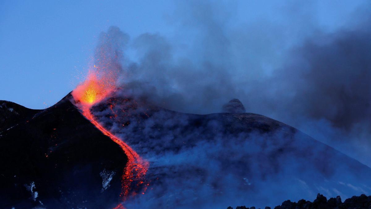 Italy's Mount Etna, Europe's tallest and most active volcano, spews lava as it erupts on the souther