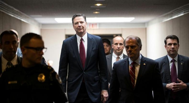 Former FBI director James Comey, center, leaving a closed hearing of the Senate Intelligence Committee on Thursday