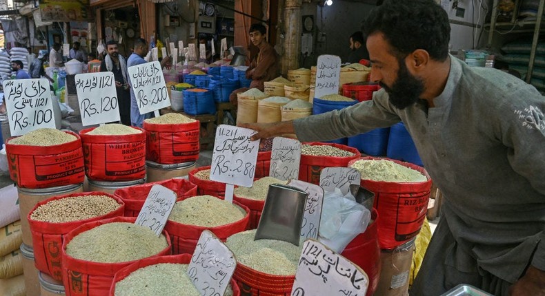 A Pakistani shopkeeper arranges price tags on rice sacks at his grocery shopAsif Hassan/AFP via Getty Images