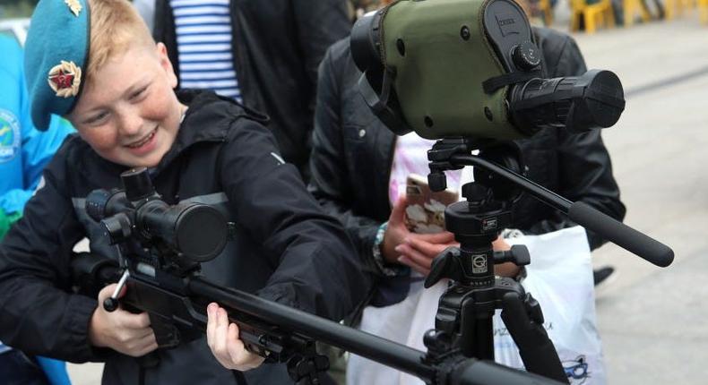 boy with a machine gun during celebrations marking Day of the Russian Airborne Troops, on August 2, 2019.
