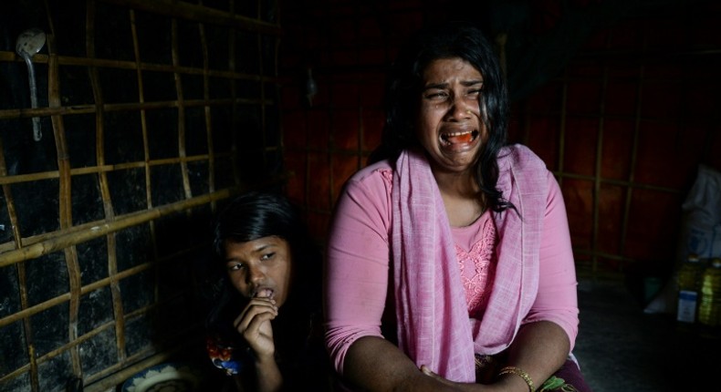 Dildar Begum, with her daughter, says Myanmar soldiers killed her husband and two young sons