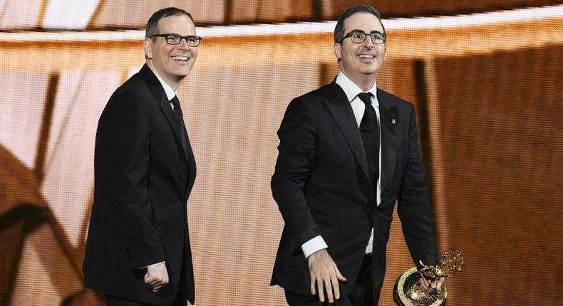 Writer/producer Tim Carvell (L) and TV personality John Oliver accept Outstanding Variety Talk Series for 'Last Week Tonight with John Oliver' at the 2016 Emmy Awards