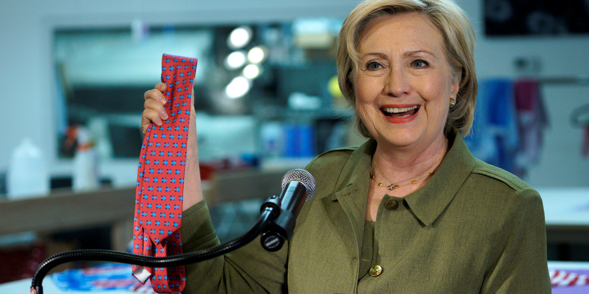 Hillary Clinton holds one of Donald Trump's ties during an event in Denver, Colorado. The tie was manufactured in China.