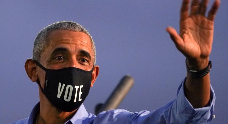 Former President Barack Obama waves while wearing a Vote mask as he campaigns on behalf of Joe Biden in Philadelphia, Pennsylvania, on October 21, 2020.
