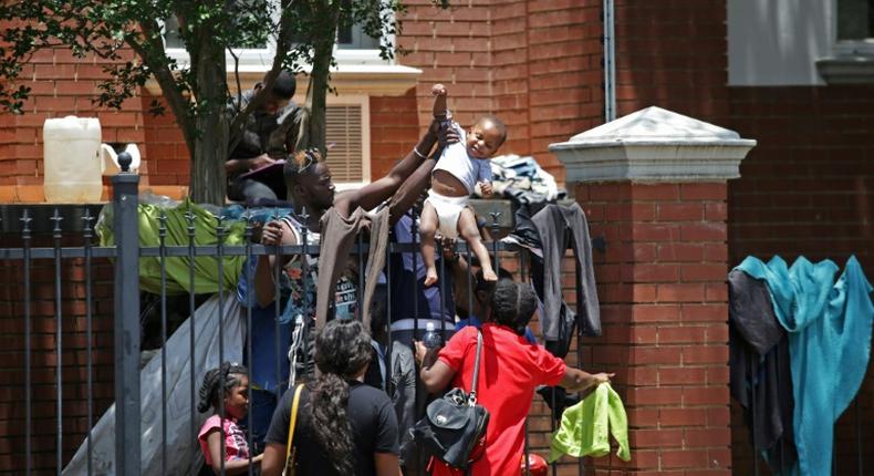 Several hundred asylum-seekers scaled the iron railings of the  United Nations High Commissioner for Refugees office in Pretoria seeking protection