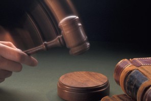 judge striking gavel in courtroom