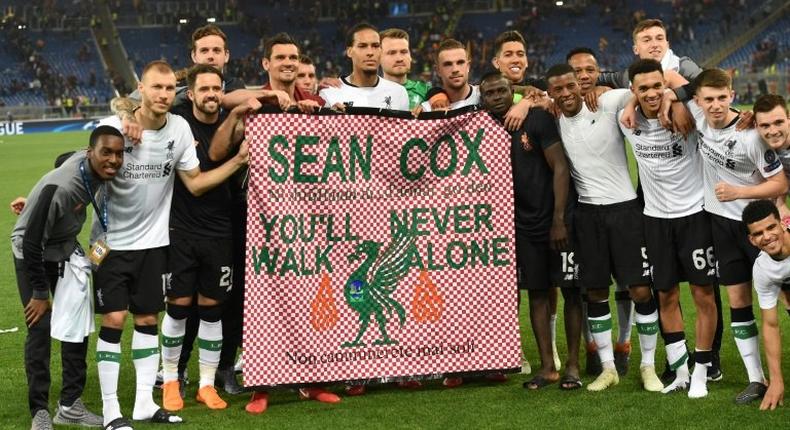 The Liverpool team, pictured May 2018, hold a tribute to Sean Cox