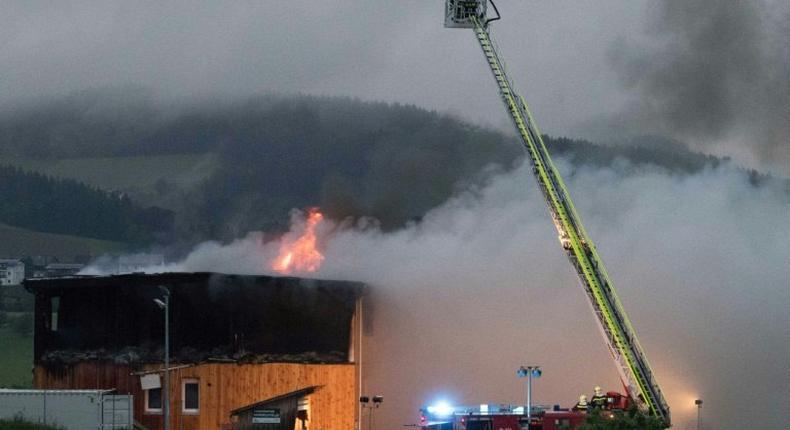 Firemen extinguish a fire at a newly-built asylum seeker centre in Altenfelden, northern Austria, on June 1, 2016, with arson suspected