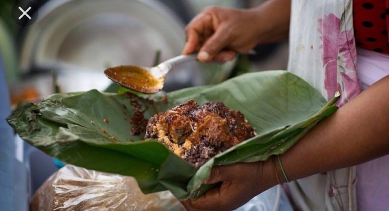 Waakye seller serving the food