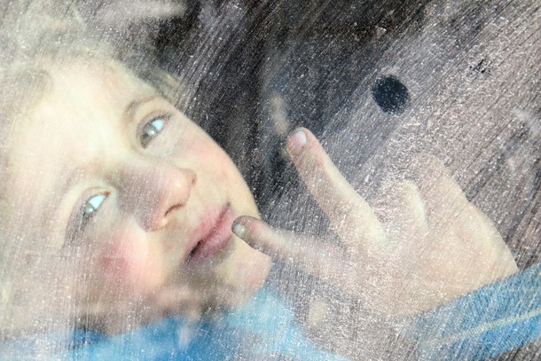 A boy flashes the victory sign while riding a bus to be evacuated from a rebel-held sector of easter